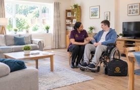 Spinal Injury Care – Homepage Service Revive Rise nurse supporting a wheelchair user with spinal injury care at home
